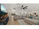 Comfortable living room with a large sectional sofa, ceiling fan, and adjacent kitchen area at 4040 E Becker Ln, Phoenix, AZ 85028
