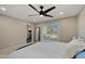 Comfortable bedroom featuring a ceiling fan, sliding glass door to the patio, and a neutral color palette at 4040 E Becker Ln, Phoenix, AZ 85028