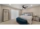 Serene main bedroom with a tufted headboard, soft lighting, and a stylish blue storage bench at the foot of the bed at 4040 E Becker Ln, Phoenix, AZ 85028