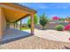 An extended covered patio with well-manicured landscaping and paver patio at 40479 W Marion May Ln, Maricopa, AZ 85138