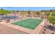 Aerial view of the community basketball court with parking and shaded picnic area nearby at 40479 W Marion May Ln, Maricopa, AZ 85138