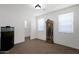 Minimalist bedroom with neutral carpet, and two bright, natural light-filled windows at 40479 W Marion May Ln, Maricopa, AZ 85138