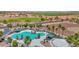 Resort-style pool with splashpad surrounded by lush landscaping and shaded lounging areas at 40479 W Marion May Ln, Maricopa, AZ 85138