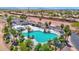 Aerial view of community pool with splashpad, cabanas, and plenty of lounging space at 40479 W Marion May Ln, Maricopa, AZ 85138