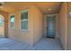 View of a home's front porch with a blue front door and dual windows under a covered porch at 40479 W Marion May Ln, Maricopa, AZ 85138