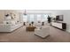 A bright and airy living room is adorned with elegant white furniture and modern decor at 40479 W Marion May Ln, Maricopa, AZ 85138