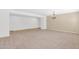 Spacious living room with neutral carpeting and a decorative light fixture at 40479 W Marion May Ln, Maricopa, AZ 85138
