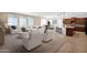 Bright, open-concept living area with modern furnishings and a seamless transition to the kitchen at 40479 W Marion May Ln, Maricopa, AZ 85138