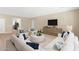 Cozy living room with sectional sofa, chairs, and modern decor at 40479 W Marion May Ln, Maricopa, AZ 85138