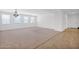 A bright living area features carpet and a light fixture at 40479 W Marion May Ln, Maricopa, AZ 85138