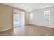 Bright room with large windows and sliding door leading to outdoor space at 40479 W Marion May Ln, Maricopa, AZ 85138