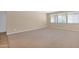 A neutral tone living room showing ample space at 40479 W Marion May Ln, Maricopa, AZ 85138