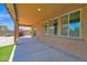 Inviting covered patio with exterior windows and pavers at 40479 W Marion May Ln, Maricopa, AZ 85138