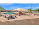 Community playground with covered seating area, perfect for families to enjoy outdoor time at 40479 W Marion May Ln, Maricopa, AZ 85138