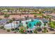 Aerial view of a community pool featuring palm trees, lounge chairs, and covered seating areas for residents' relaxation at 40479 W Marion May Ln, Maricopa, AZ 85138