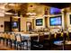 Upscale bar with modern lighting, multiple TVs, bar seating, and a wide selection of beverages at 40614 N Harbour Town Ct, Anthem, AZ 85086