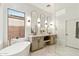 Elegant bathroom with a soaking tub, dual vanity, and modern finishes at 40614 N Harbour Town Ct, Anthem, AZ 85086
