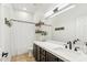 Modern bathroom with a white vanity, dark cabinetry, and stylish fixtures at 40614 N Harbour Town Ct, Anthem, AZ 85086
