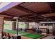 Outdoor bocce ball court beneath a covered patio, complemented by comfortable seating and scenic landscaping at 40614 N Harbour Town Ct, Anthem, AZ 85086