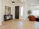 Inviting foyer featuring a modern table, decorative mirror, and hardwood floors at 40614 N Harbour Town Ct, Anthem, AZ 85086