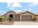 Charming single-story home with a tile roof, three-car garage, and desert landscaping at 40614 N Harbour Town Ct, Anthem, AZ 85086