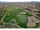 Scenic aerial shot of a meticulously maintained golf course and surrounding houses at 40614 N Harbour Town Ct, Anthem, AZ 85086