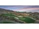 Picturesque golf course view with lush green fairways and mountain backdrop at 40614 N Harbour Town Ct, Anthem, AZ 85086
