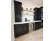 Kitchen bar featuring custom dark cabinetry, floating shelves, stainless steel wine fridge, and white countertops at 40614 N Harbour Town Ct, Anthem, AZ 85086