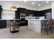 Modern kitchen with stainless steel appliances, black cabinetry, and a center island at 40614 N Harbour Town Ct, Anthem, AZ 85086