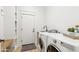Convenient laundry room equipped with washer, dryer, sink, and storage at 40614 N Harbour Town Ct, Anthem, AZ 85086
