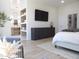 Bright main bedroom showcasing stylish built-ins, a wall-mounted TV, and ensuite bathroom access at 40614 N Harbour Town Ct, Anthem, AZ 85086