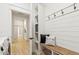 Mudroom featuring a wood bench, storage cubbies, white shiplap wall, and hooks for added convenience at 40614 N Harbour Town Ct, Anthem, AZ 85086