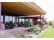 Outdoor patio with ample seating, lush landscaping, and string lights, perfect for enjoying the outdoors at 40614 N Harbour Town Ct, Anthem, AZ 85086