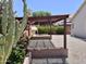Backyard featuring pergola, fireplace, desert plants and greenery at 4224 E Renee Dr, Phoenix, AZ 85050