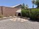 Backyard with brick-lined firepit and walls, gravel ground cover, and greenery at 4224 E Renee Dr, Phoenix, AZ 85050