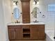 Modern bathroom with double vanities, granite countertops, custom cabinetry, and oval mirrors, perfect for a couple at 4224 E Renee Dr, Phoenix, AZ 85050