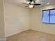 Empty bedroom with a ceiling fan and a window with blinds at 4224 E Renee Dr, Phoenix, AZ 85050