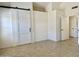 Open bedroom with a sliding barn door and neutral tile flooring at 4224 E Renee Dr, Phoenix, AZ 85050