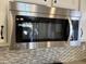 Stainless steel microwave oven above a white-tiled backsplash at 4224 E Renee Dr, Phoenix, AZ 85050