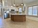 Modern kitchen with stainless steel appliances, custom cabinets, granite countertops, and a central island at 4224 E Renee Dr, Phoenix, AZ 85050