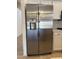 Side-by-side stainless steel refrigerator with water and ice dispenser, complementing white cabinetry at 4224 E Renee Dr, Phoenix, AZ 85050