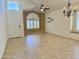 Bright living room with tile floors, arched windows, ceiling fan, and neutral paint, offering a versatile space at 4224 E Renee Dr, Phoenix, AZ 85050