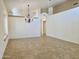 Spacious living room with natural light, featuring tile flooring, neutral walls, and a hanging chandelier at 4224 E Renee Dr, Phoenix, AZ 85050