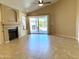 Inviting living room featuring a cozy fireplace, tile flooring, and a sliding glass door leading to the backyard at 4224 E Renee Dr, Phoenix, AZ 85050