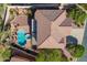 Bird's eye view of a well-maintained home featuring a clay tile roof, pool, patio, and lush desert landscaping at 4264 S Columbine Way, Gold Canyon, AZ 85118