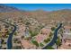 An elevated view displays a desert community nestled at the base of picturesque mountains at 4264 S Columbine Way, Gold Canyon, AZ 85118