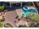 Aerial shot showcasing the backyard oasis with pool, spa, covered patio, and lush desert landscaping at 4264 S Columbine Way, Gold Canyon, AZ 85118