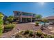 Large backyard with pool, mature landscaping, covered patio, second story balcony and a two-story home at 4264 S Columbine Way, Gold Canyon, AZ 85118