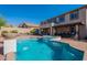 Gorgeous backyard featuring a pool, spa, covered patio, and second story balcony at 4264 S Columbine Way, Gold Canyon, AZ 85118