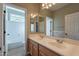 Well-lit bathroom featuring double sinks, a large mirror, and a separate toilet and shower area at 4264 S Columbine Way, Gold Canyon, AZ 85118